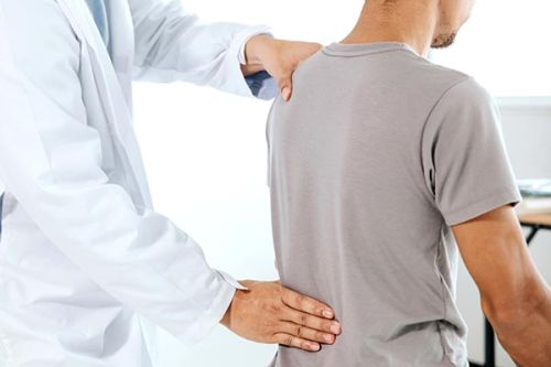 Patient receiving care from chiropractor to relieve back pain