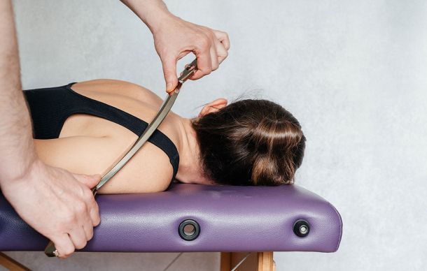 Assisted soft tissue manipulation for back ache